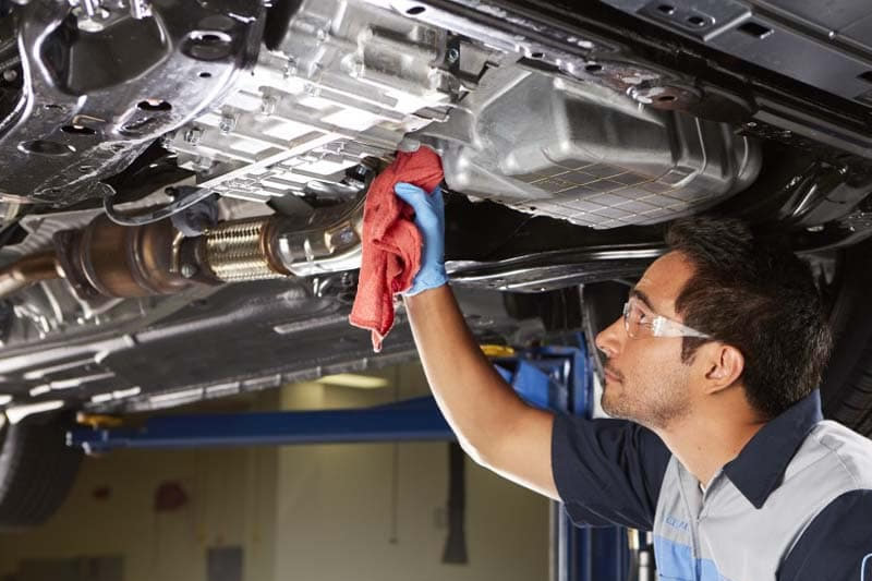 photo of mechanics servicing an automatic transmission